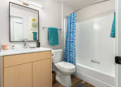 Thumbnail 26 of 27 - a bathroom with a shower toilet and sink