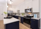 Thumbnail 13 of 59 - model apartment kitchen with cabinets and quartz countertops at Element 12 Apartments, Henderson NV