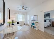 Thumbnail 17 of 59 - a living room with a reflection of a bedroom in a glass wall at Element 12 Apartments, Henderson NV
