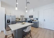 Thumbnail 2 of 59 - a kitchen with an island and a stainless steel refrigeratorat Element 12 Apartments, Henderson NV