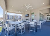 Thumbnail 44 of 59 - a patio with tables and chairs and a fireplace at Element 12 Apartments, Henderson NV