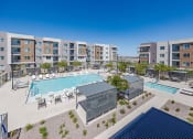 Thumbnail 4 of 59 - a view of a pool with an apartment building in the background at Element 12 Apartments, Henderson NV