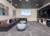Thumbnail 37 of 59 - a living room with couches and a fireplace and a tv at Element 12 Apartments, Henderson NV