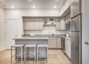 Thumbnail 3 of 42 - a kitchen with a island and three stools