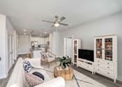 Thumbnail 15 of 30 - Bright apartment living room with large windows and contemporary furnishings