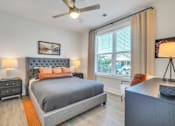 Thumbnail 27 of 30 - Modern bedroom with upholstered bed, ceiling fan and large windows