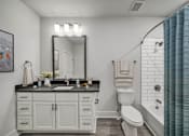 Thumbnail 29 of 30 - Modern apartment bathroom with vanity, mirror and glass-enclosed shower