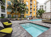 Thumbnail 24 of 34 - A pool surrounded by chairs and palm trees.