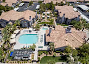 Thumbnail 63 of 63 - A large swimming pool surrounded by a tiled roofed building.