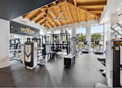 Thumbnail 6 of 58 - a spacious fitness center with cardio equipment and large windows