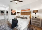 Thumbnail 4 of 58 - a bedroom with a bed and a ceiling fan