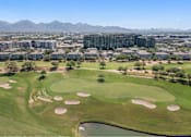 Thumbnail 56 of 58 - an aerial view of a golf course with a city in the background