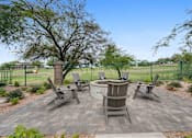 Thumbnail 50 of 58 - an outdoor patio with a firepit and chairs