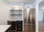 Thumbnail 16 of 58 - a renovated kitchen with stainless steel refrigerator and white counter tops