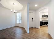 Thumbnail 17 of 58 - an empty living room with white walls and wood floors