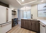 Thumbnail 11 of 58 - a kitchen with a sink and a refrigerator