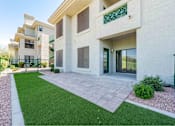 Thumbnail 22 of 58 - a patio in front of a building with green grass