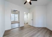 Thumbnail 19 of 58 - an empty living room with white walls and a ceiling fan