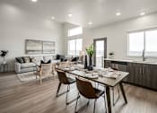 Thumbnail 9 of 12 - A modern dining room with a wooden table and chairs.