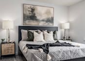 Thumbnail 10 of 12 - A bedroom with a large bed and a painting above it.