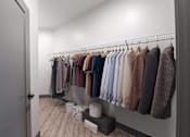 Thumbnail 36 of 79 - A row of clothes hanging on a rack in a room.