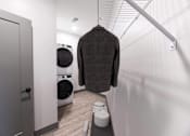 Thumbnail 53 of 79 - A brown sweater hanging on a rail in a laundry room.
