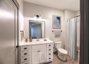 Thumbnail 59 of 79 - A bathroom with a white vanity and a toilet.