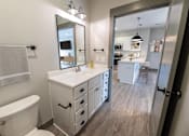 Thumbnail 45 of 79 - A white bathroom with a white toilet and a white sink.