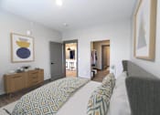 Thumbnail 50 of 79 - A bedroom with a bed, chair, and a painting on the wall.