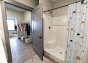 Thumbnail 55 of 79 - A bathroom with a shower and a wardrobe.