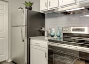 Thumbnail 7 of 24 - Kitchen with white cabinets and stainless steel refrigerator at The Villas at Northstar apartments for rent in Ann Arbor.