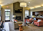 Thumbnail 12 of 24 - A living room with a fireplace and a couch.