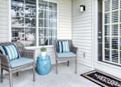 Thumbnail 10 of 24 - Two chairs and a table on a porch.