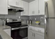 Thumbnail 2 of 30 - White cabinet kitchen with stove and refrigerator at The Villas at Northstar apartments for rent in Ann Arbor, MI