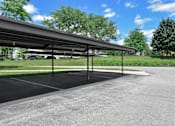 Thumbnail 24 of 30 - A parking lot with a large canopy over it.
