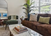 Thumbnail 3 of 22 - Cozy living room with brown couch at Kenyon Square Apartments in Polaris, Ohio