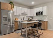 Thumbnail 8 of 61 - A kitchen with a table and chairs.