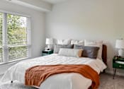 Thumbnail 2 of 61 - A bedroom with a large bed and a window with blinds.