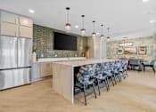Thumbnail 33 of 61 - A modern kitchen with a long island and chairs.