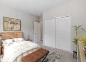 Thumbnail 38 of 61 - A bedroom with a large bed and a wooden headboard.