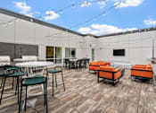 Thumbnail 53 of 61 - A patio with a table and chairs is set up on a wooden deck.