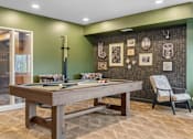 Thumbnail 58 of 61 - A pool table in a room with a green wall and a chair.