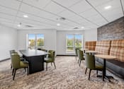 Thumbnail 50 of 61 - A conference room with a long table and chairs.