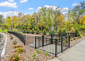 Thumbnail 41 of 61 - A black metal fence runs along a gravel path.
