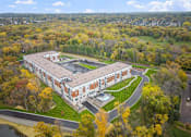 Thumbnail 44 of 61 - A large building surrounded by trees in autumn.