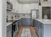 Thumbnail 2 of 76 - Kitchen with stainless appliances at The Lodge at Overland new apartments in Rochester, MN.
