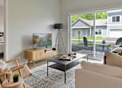 Thumbnail 3 of 76 - Living room with a patio view at The Lodge at Overland new apartments in Rochester, MN.