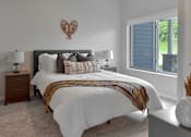 Thumbnail 9 of 76 - A bedroom with a large bed and a heart-shaped decoration on the wall.