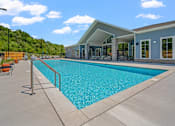 Thumbnail 15 of 76 - A large swimming pool in front of a building.