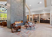 Thumbnail 23 of 76 - A modern living room with a fireplace and a dining area.